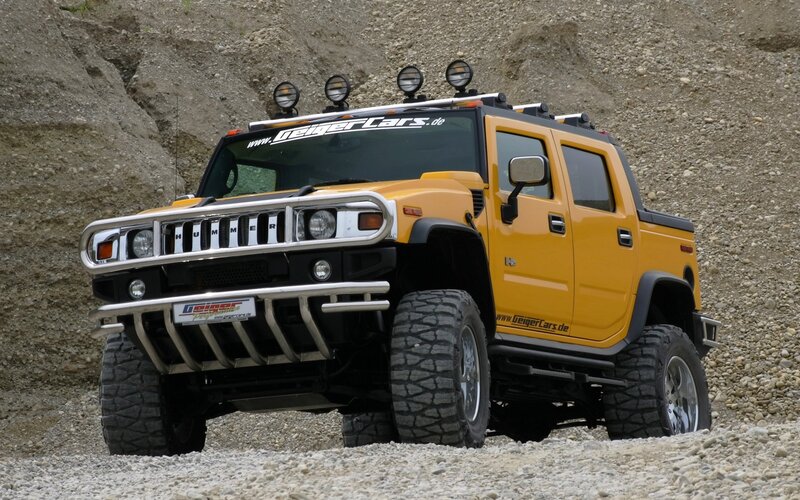 Yellow Hummer H2 in rocky terrain