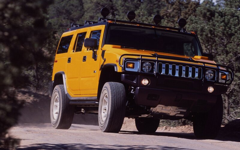 Yellow Hummer H2 on dirt road