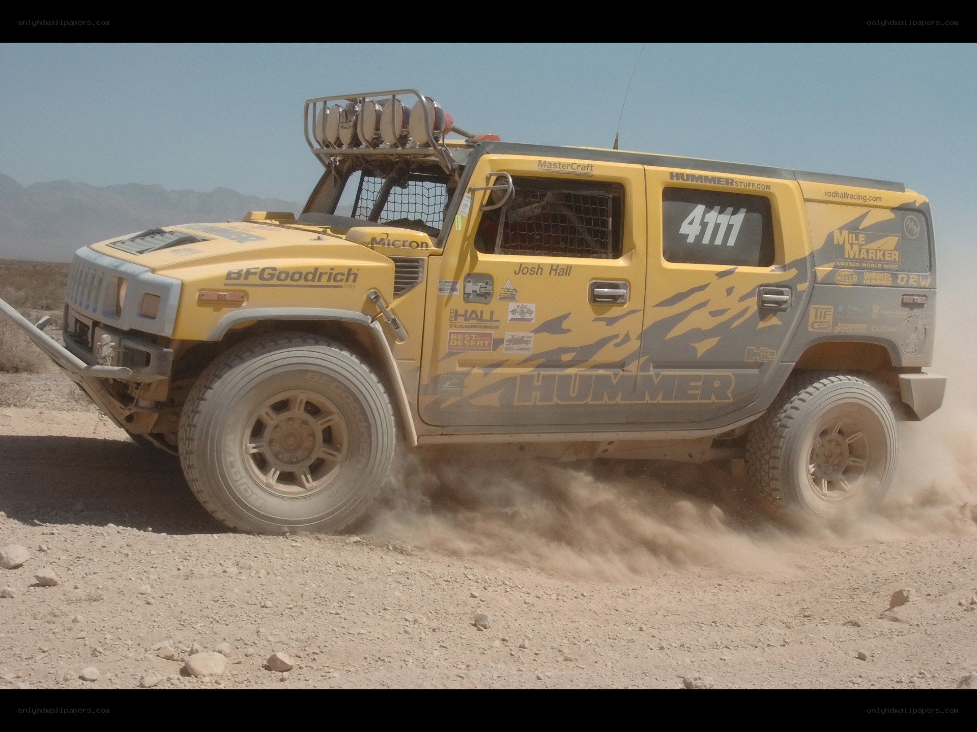 Yellow Hummer racing in desert