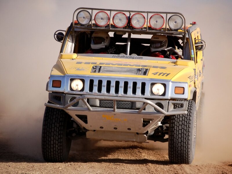 Yellow Hummer racing in dust