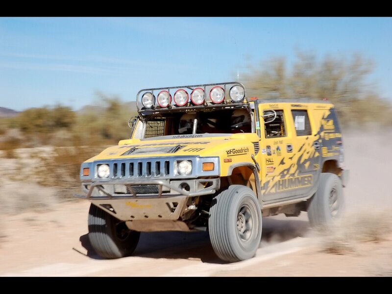 Yellow Hummer racing on dirt
