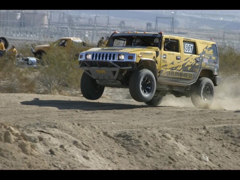 Yellow Hummer racing on dirt