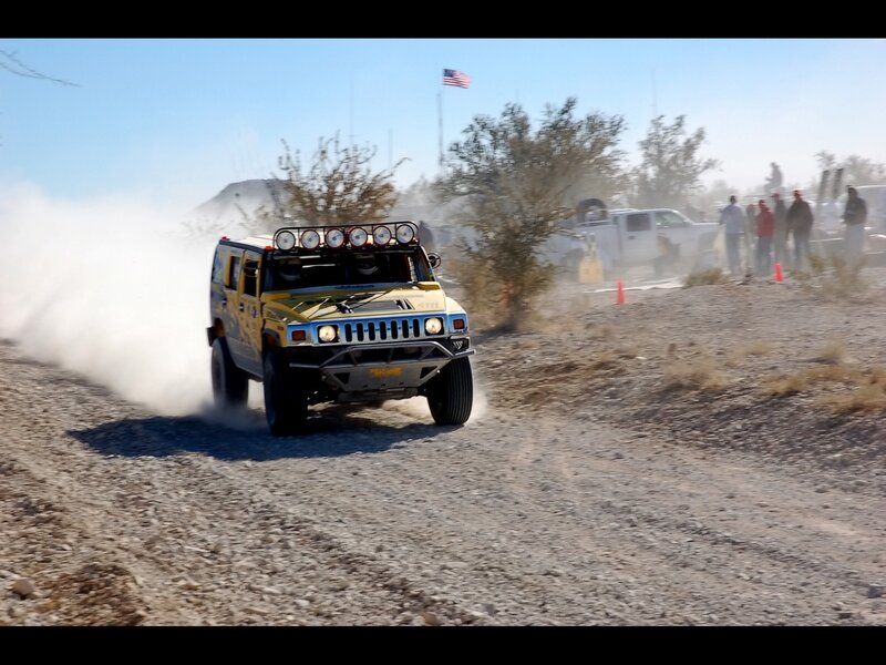 Yellow Hummer racing on dirt