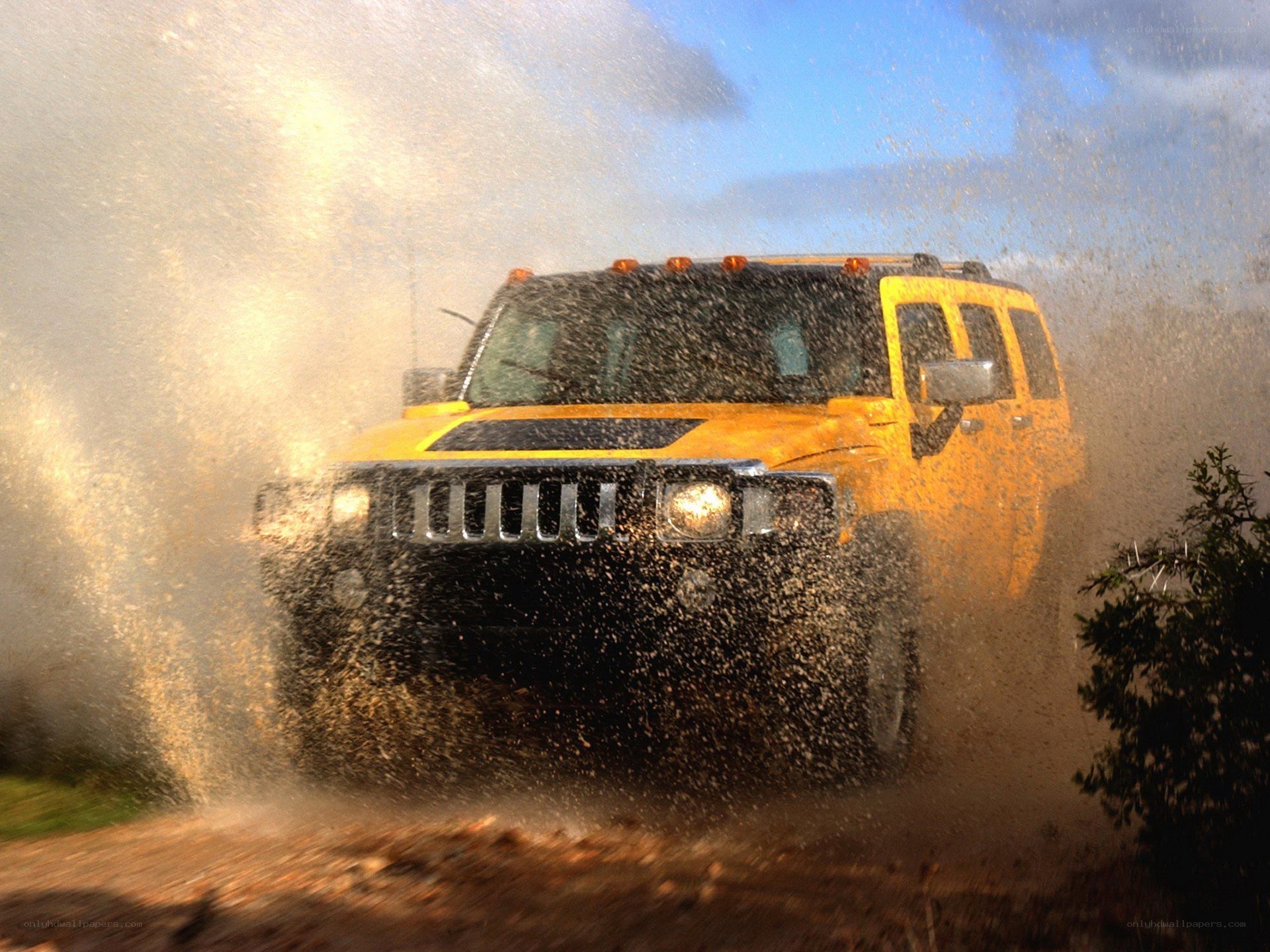 Yellow Hummer splashing through water