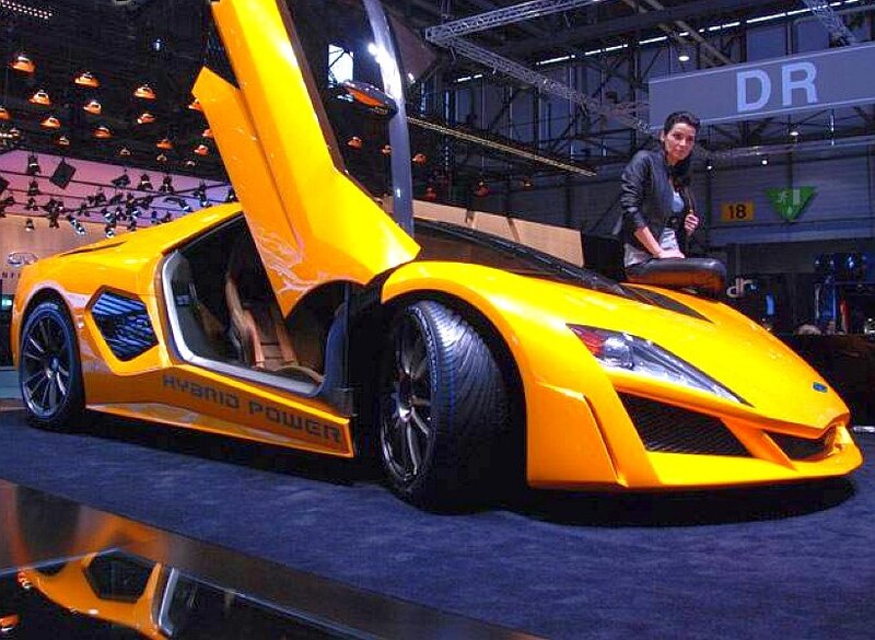 Yellow hybrid sports car on display