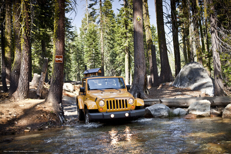 Yellow Jeep crossing a stream