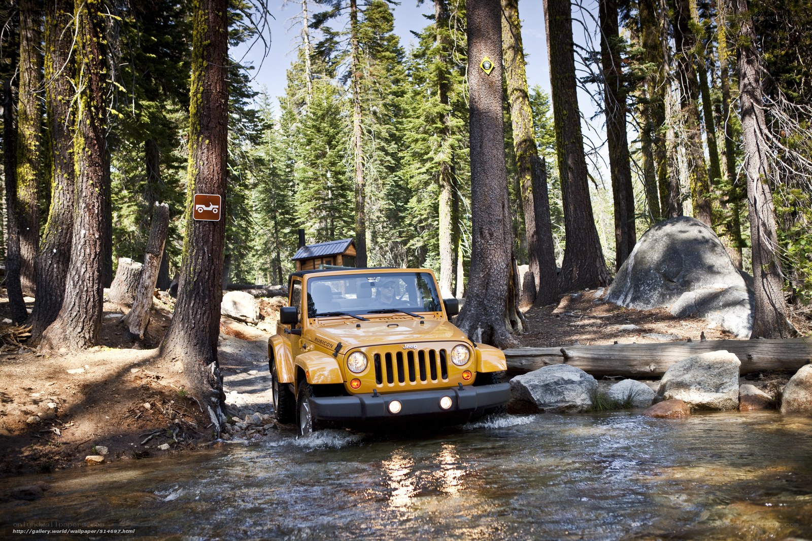 Yellow Jeep crossing a stream