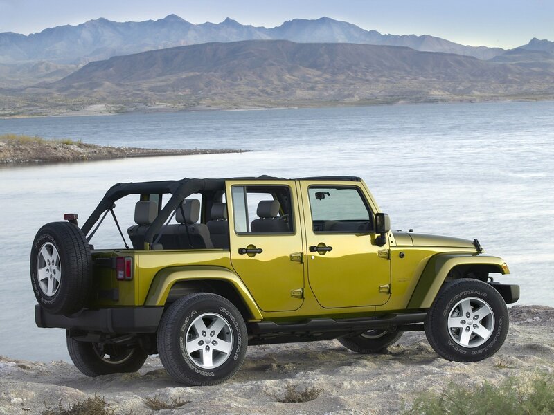 Yellow Jeep on a rocky shore