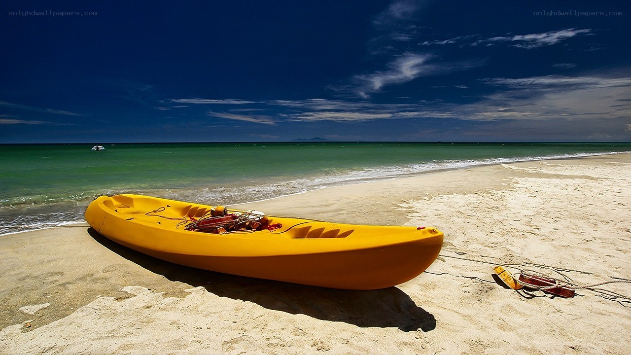 Yellow kayak on sandy beach