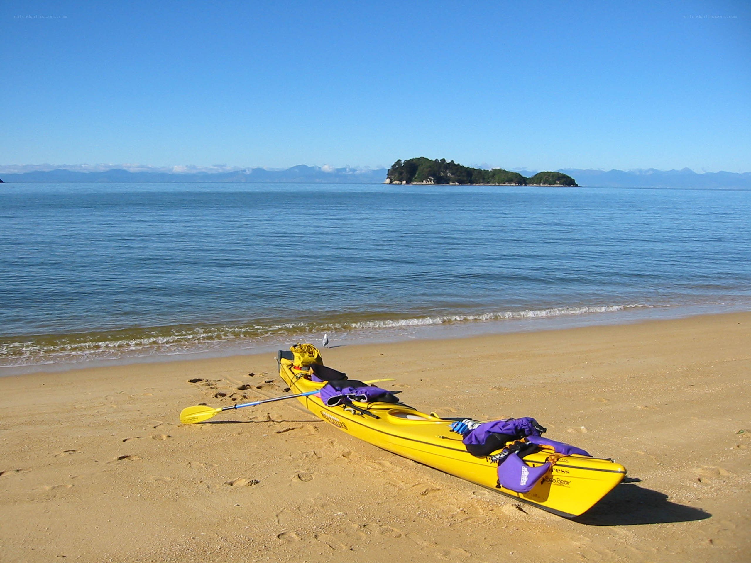 Yellow kayak on sandy beach