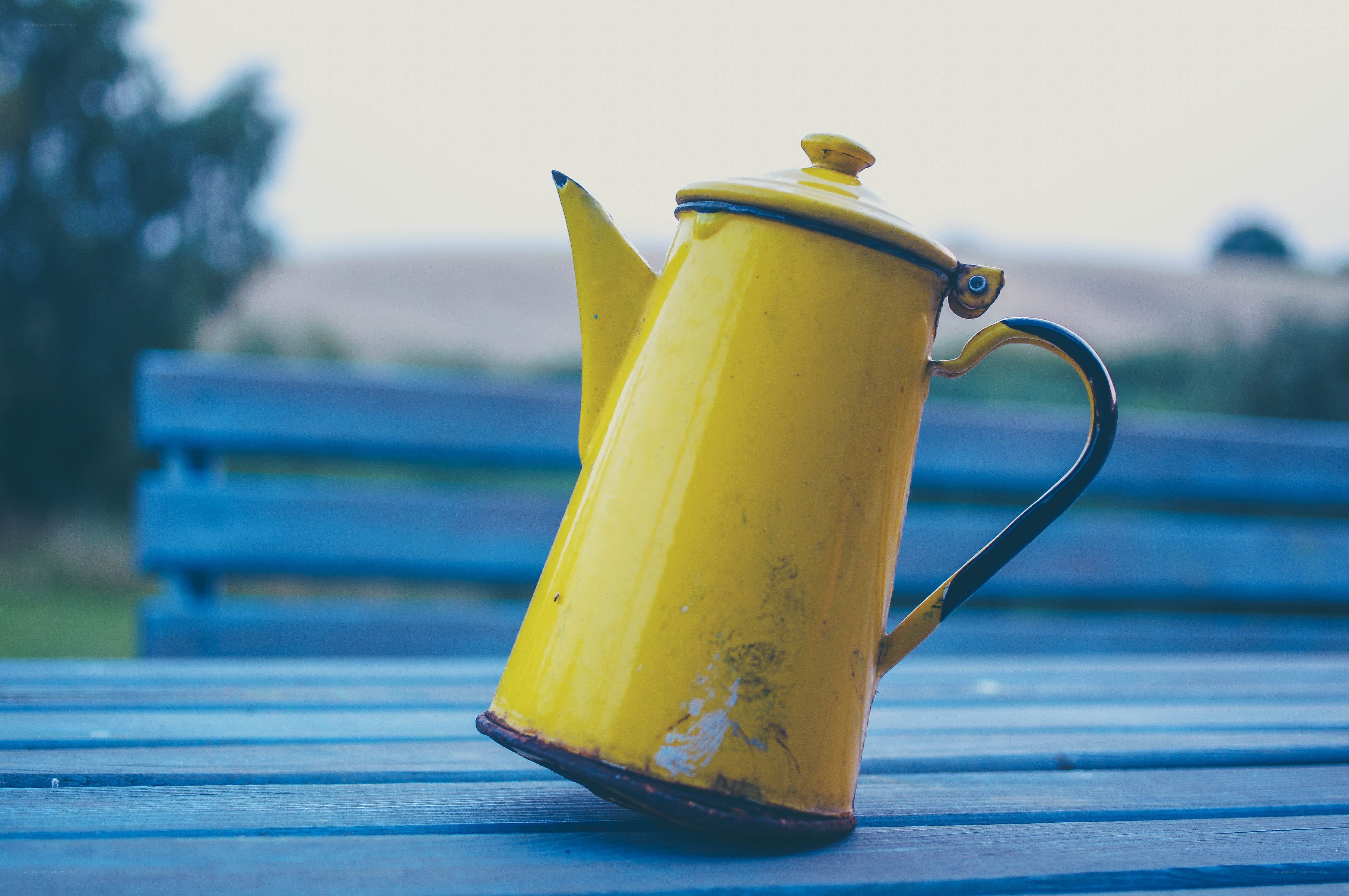 Yellow kettle on blue table