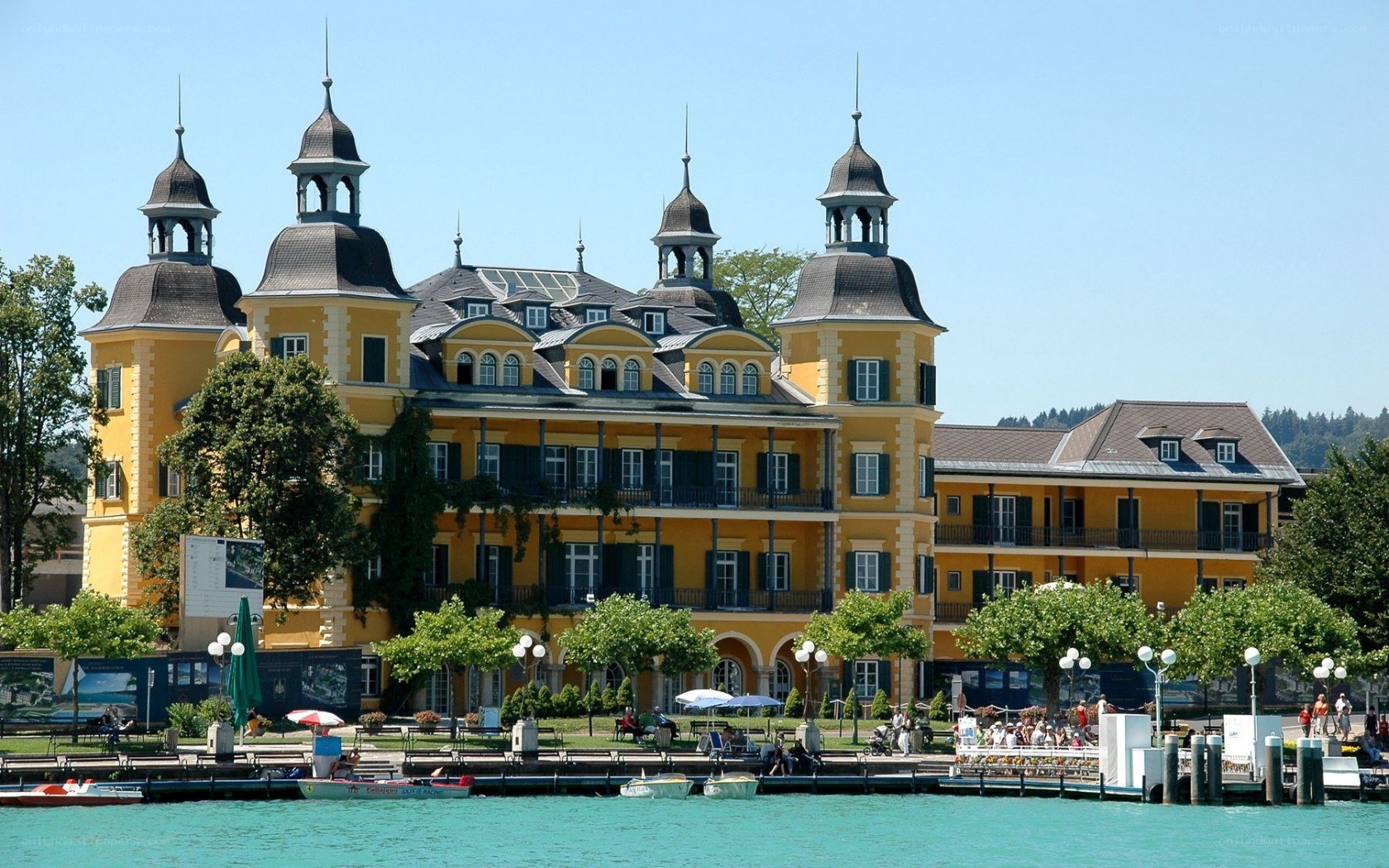Yellow lakeside building with turrets