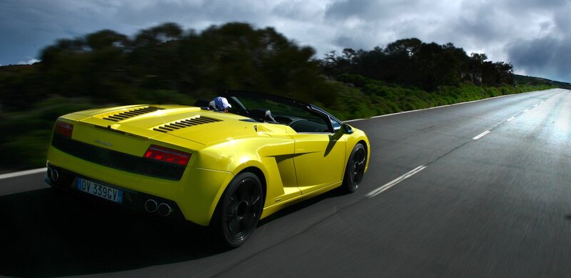 Yellow Lamborghini convertible on road