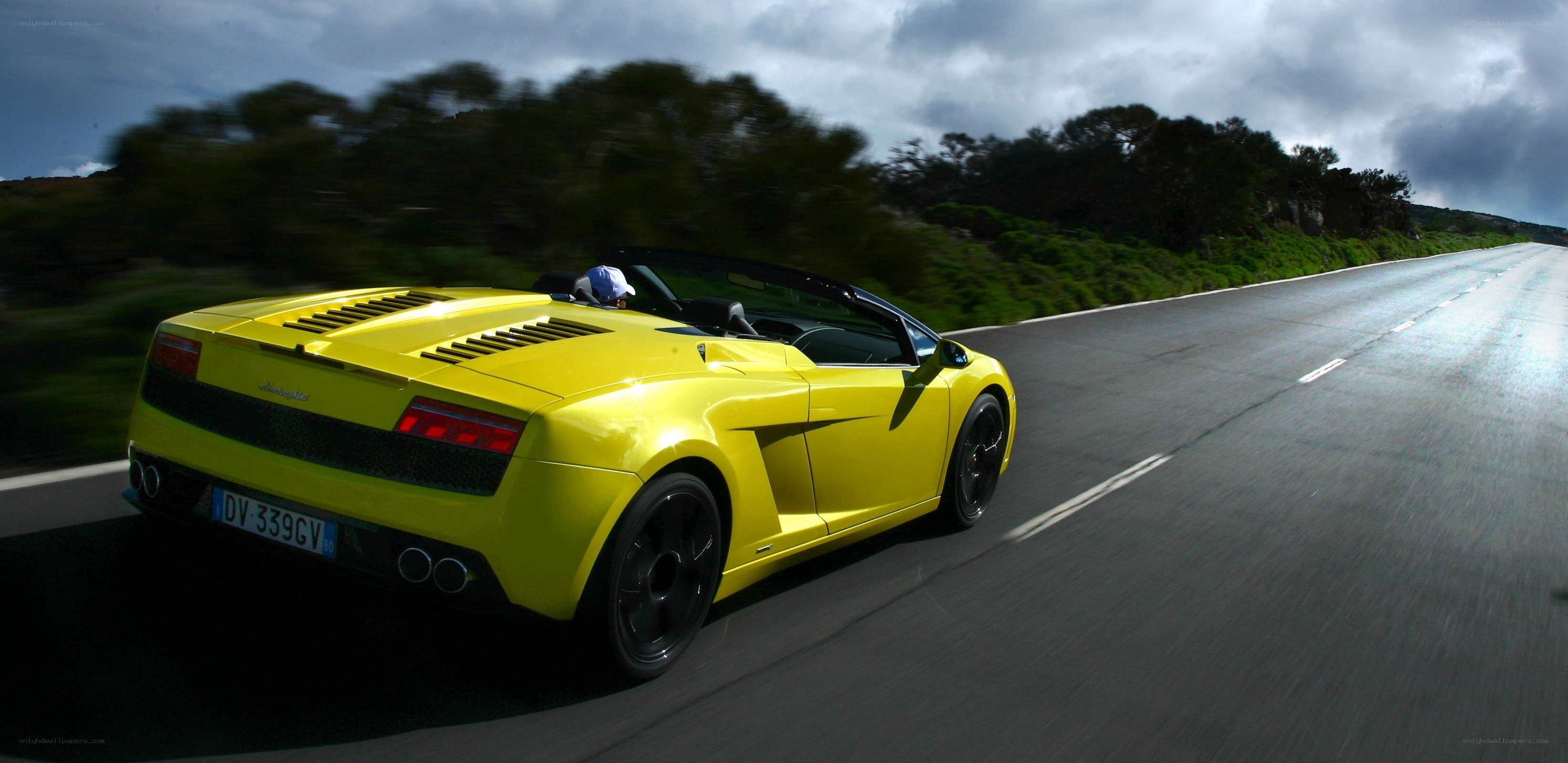 Yellow Lamborghini convertible on road