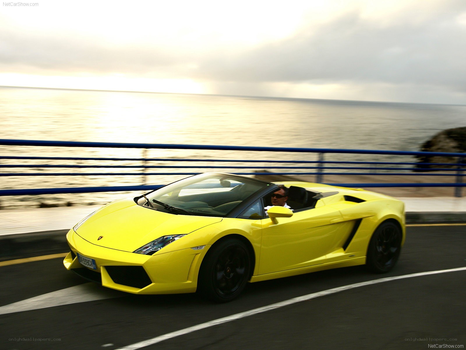 Yellow Lamborghini driving by the sea