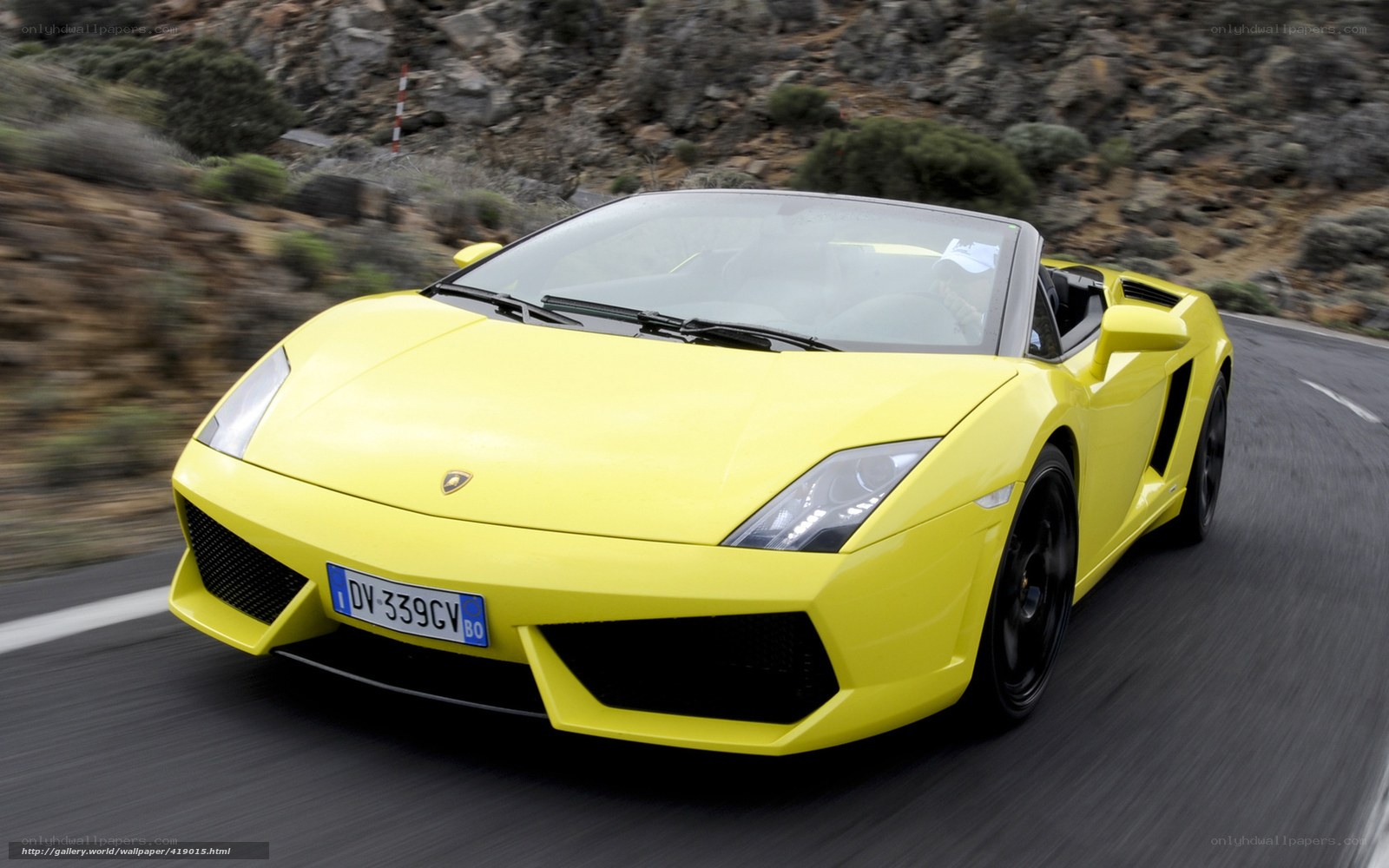 Yellow Lamborghini driving on road