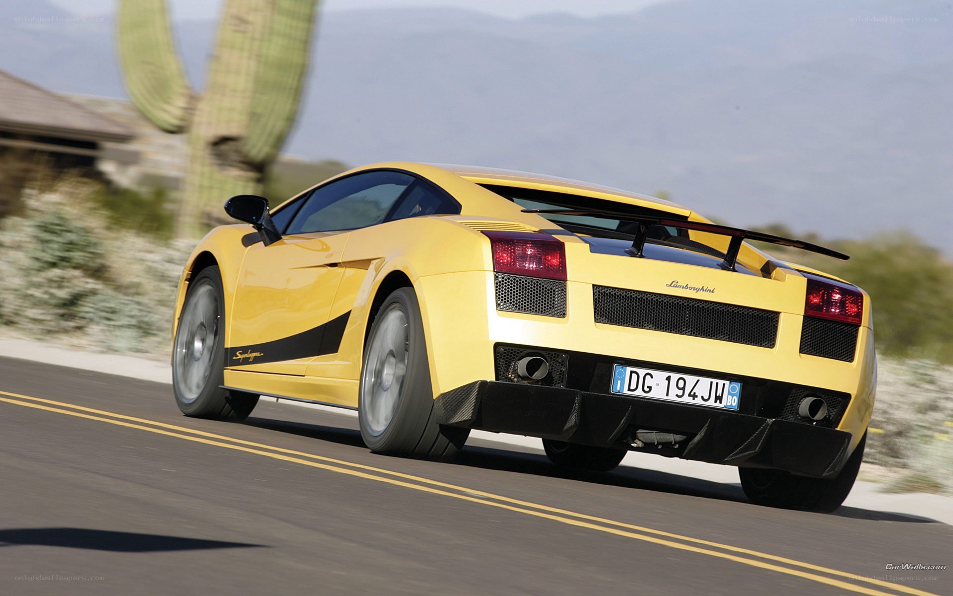 Yellow Lamborghini driving on road
