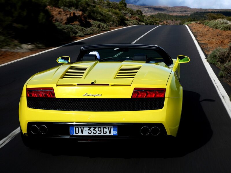 Yellow Lamborghini driving on road