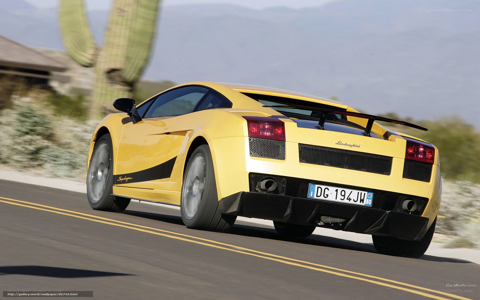 Yellow Lamborghini driving on road