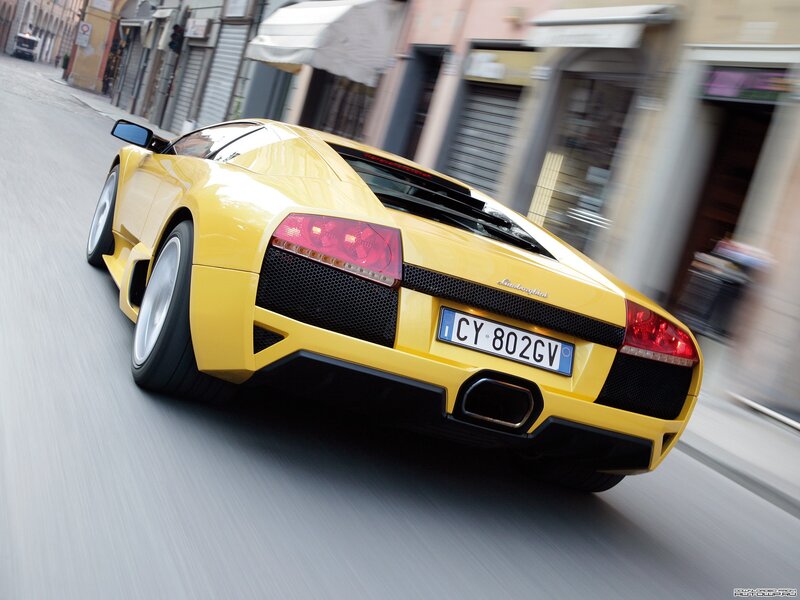 yellow lamborghini driving on street