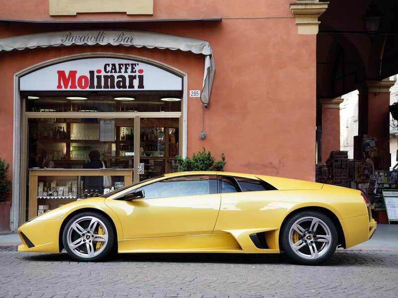 Yellow Lamborghini in front of cafe
