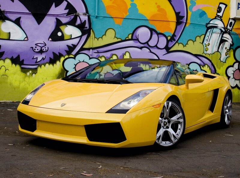 Yellow Lamborghini in front of graffiti