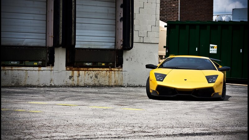 Yellow Lamborghini in industrial lot