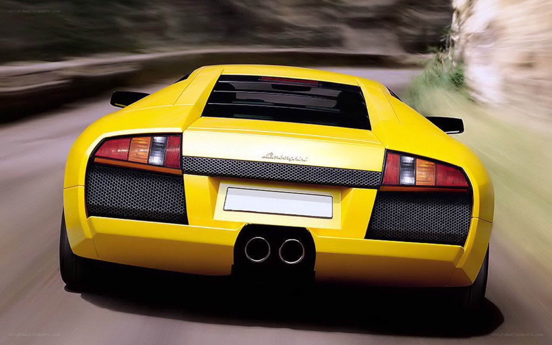 yellow lamborghini in motion