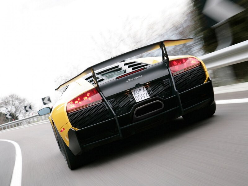 yellow lamborghini in motion
