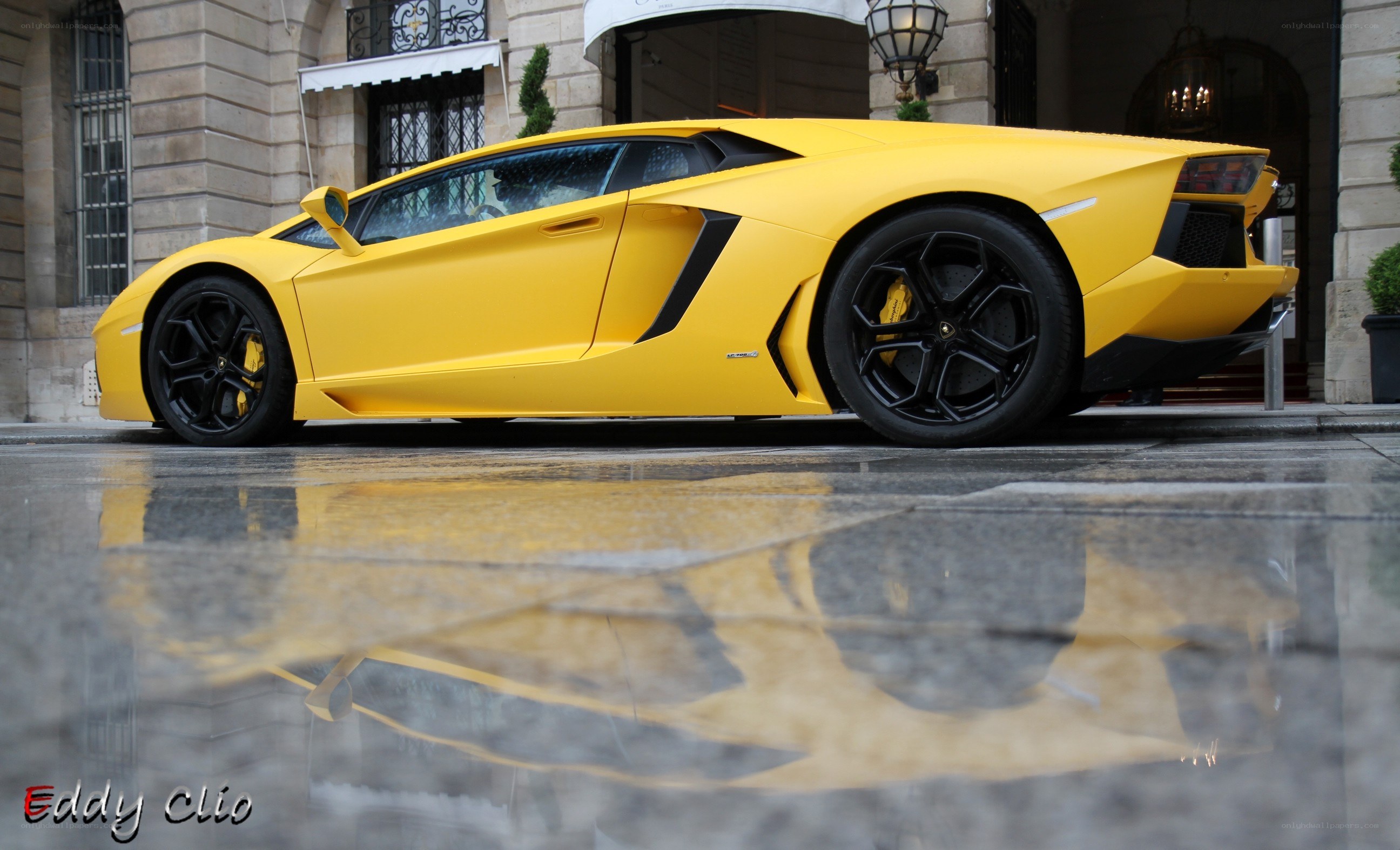 yellow lamborghini in puddle