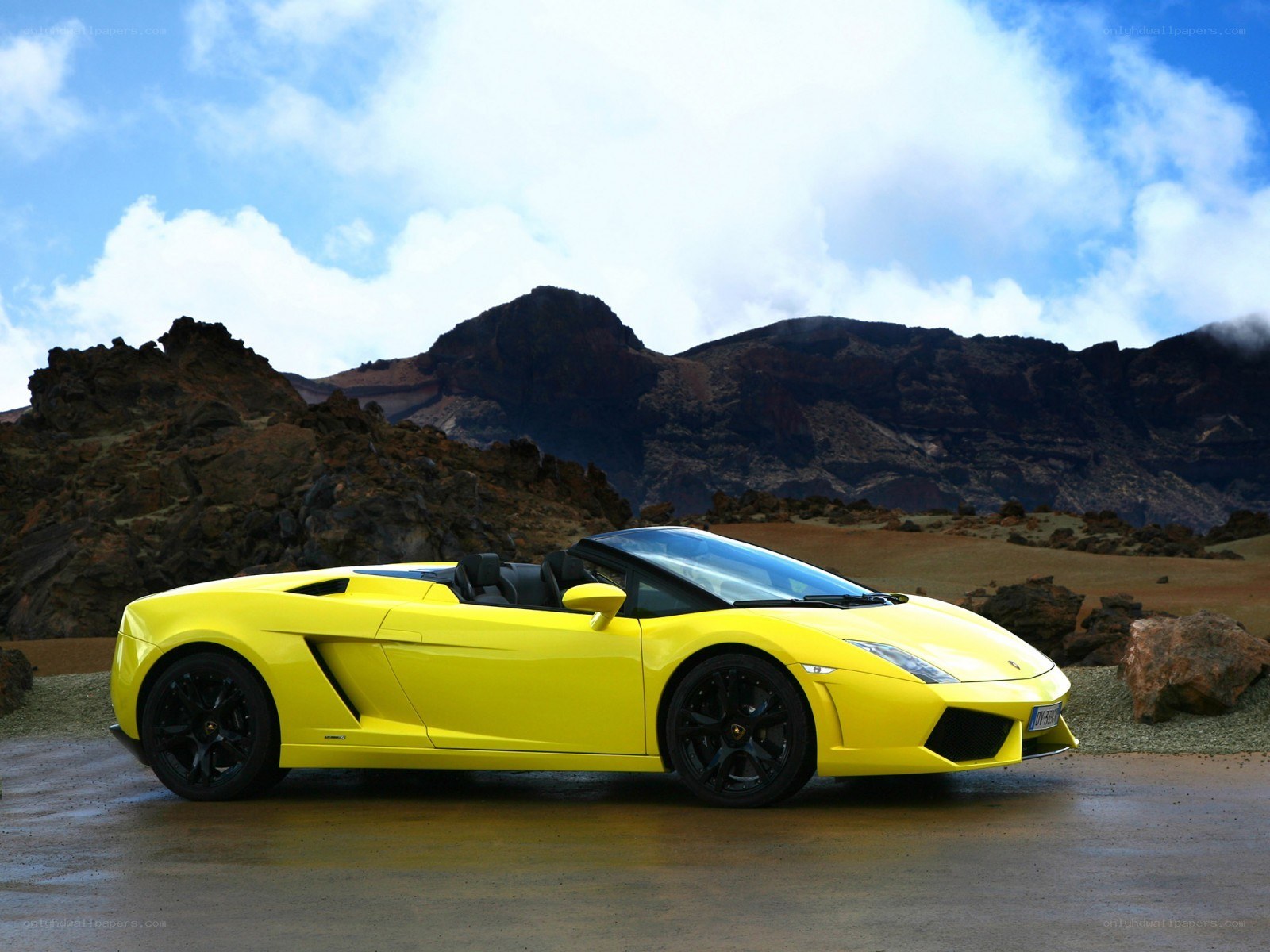 Yellow Lamborghini in volcanic landscape