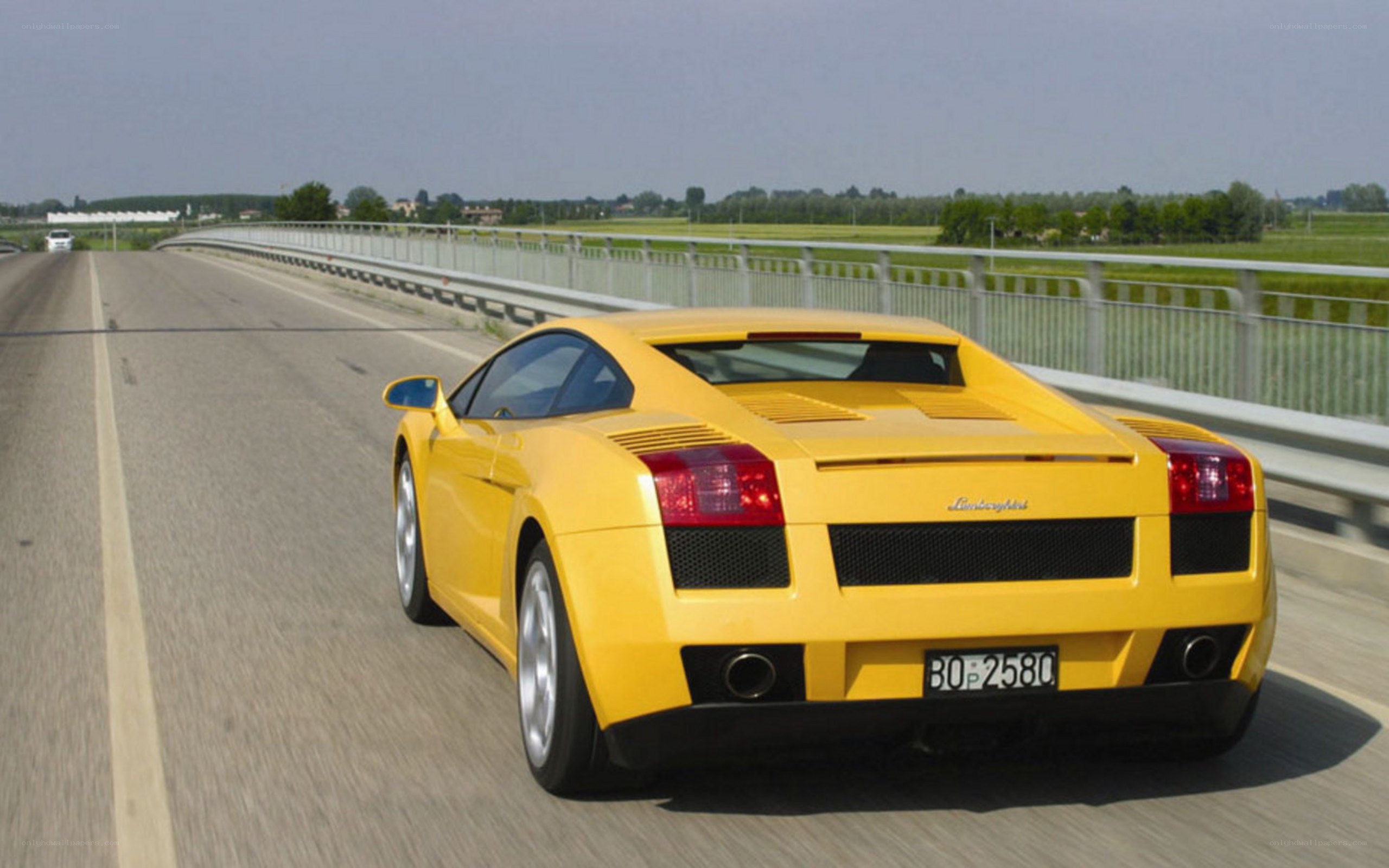 yellow lamborghini on a bridge