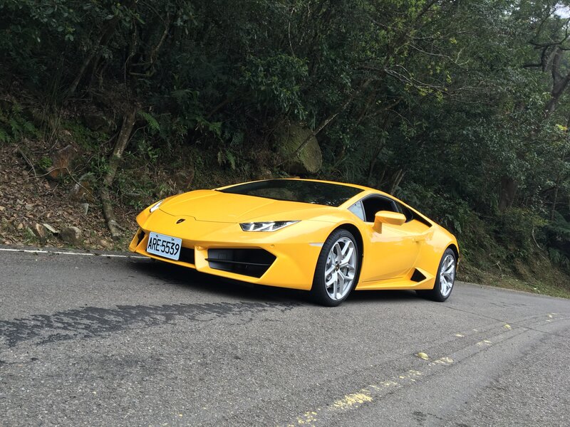 Yellow Lamborghini on a forest road