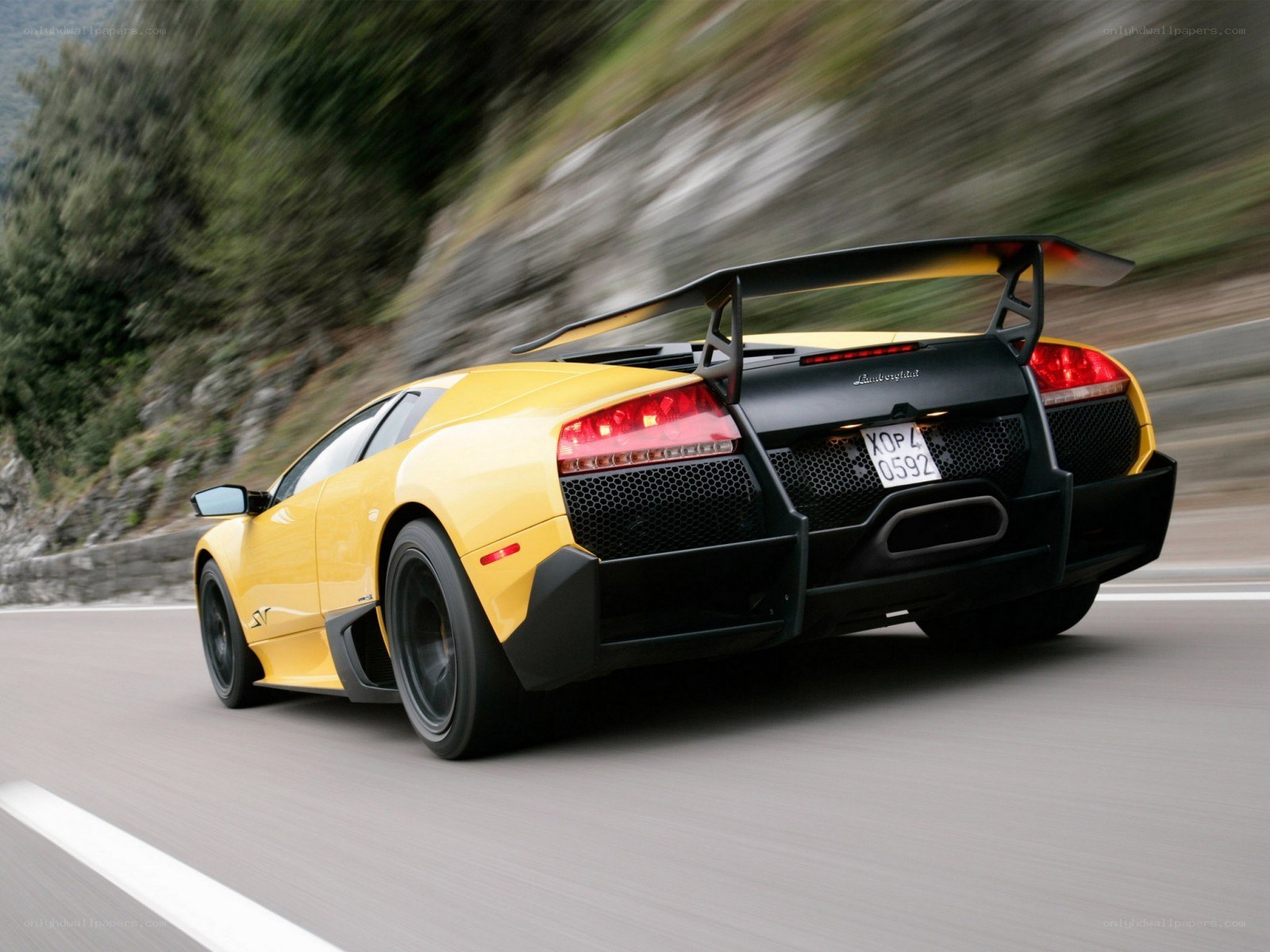 Yellow Lamborghini on a mountain road