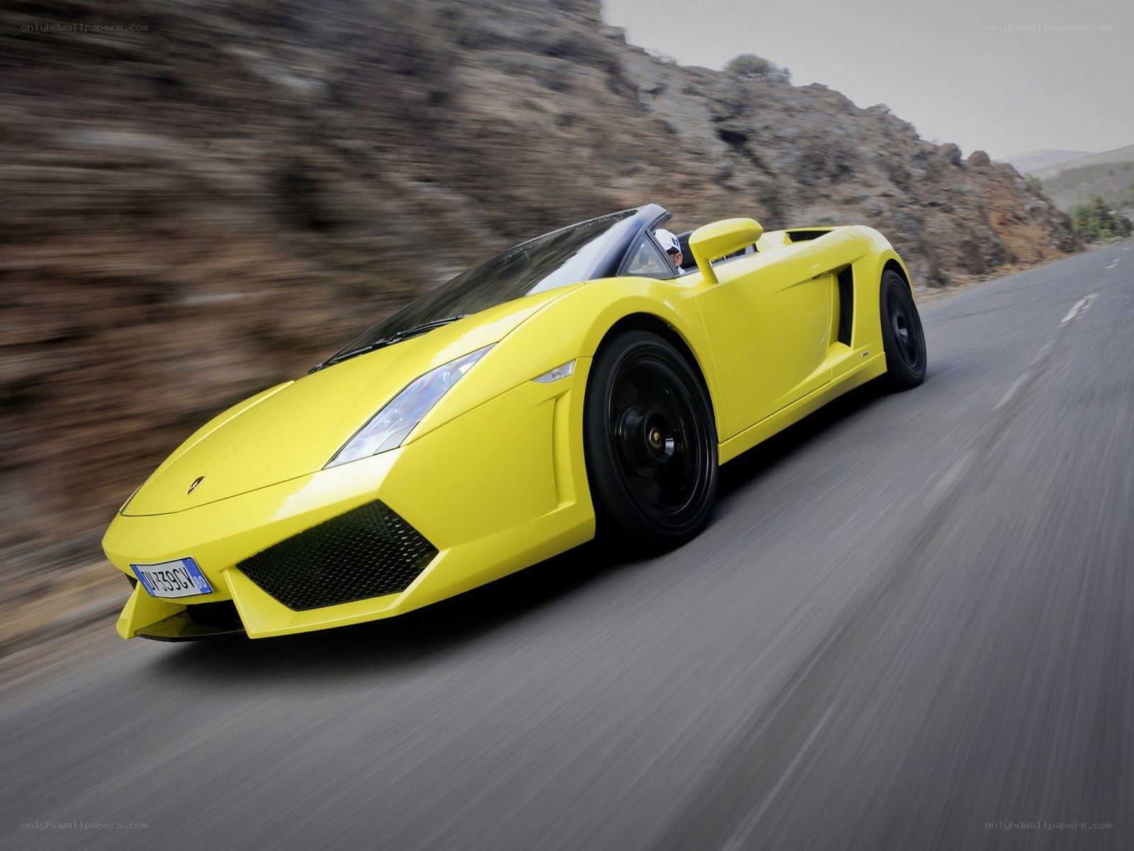Yellow Lamborghini on a mountain road