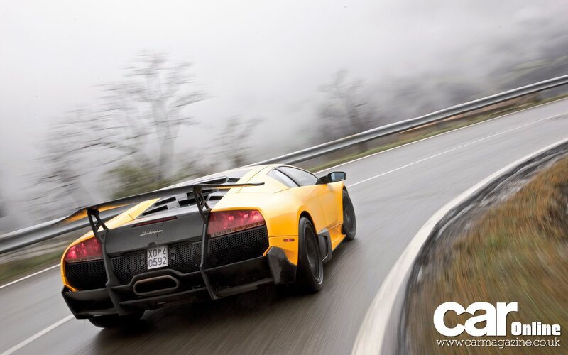 yellow lamborghini on a winding road