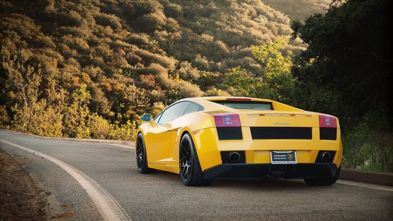 Yellow Lamborghini on a winding road