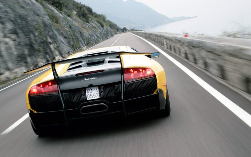 Yellow Lamborghini on coastal road