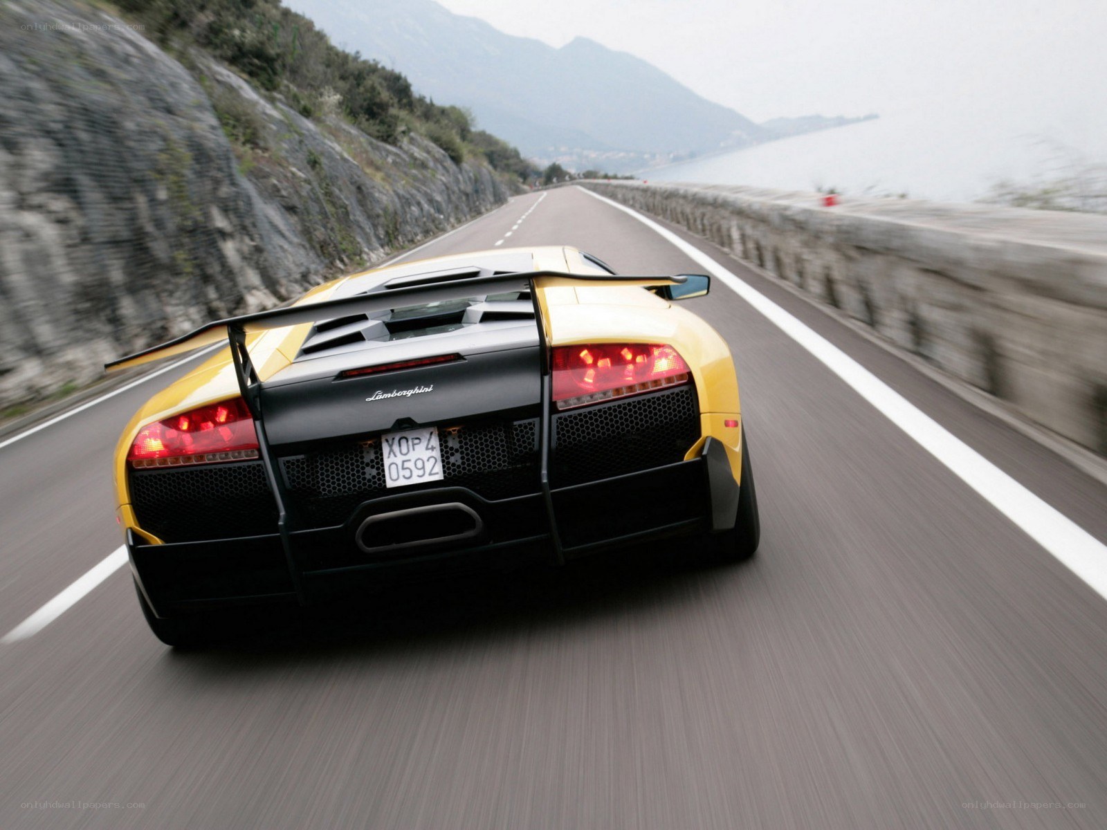 Yellow Lamborghini on coastal road