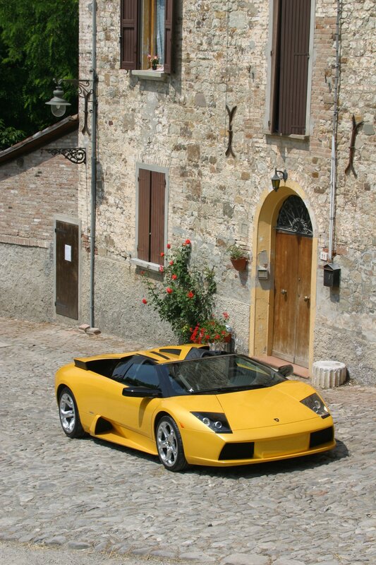 Yellow Lamborghini on cobblestone street