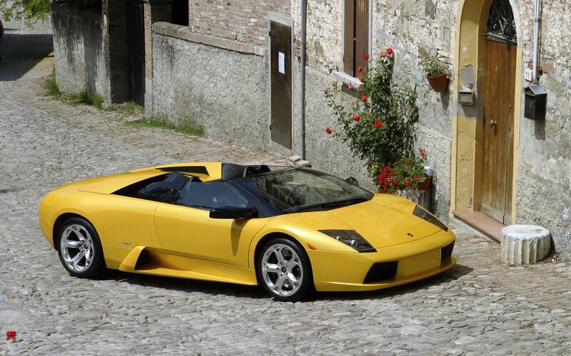 Yellow Lamborghini on cobblestone street