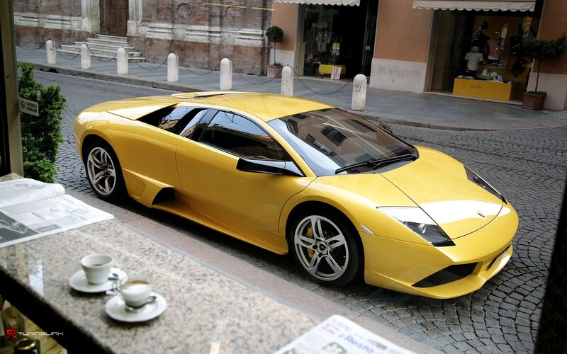 Yellow Lamborghini on cobblestone street