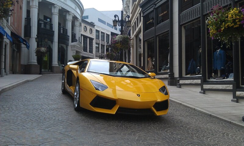 Yellow Lamborghini on cobblestone street