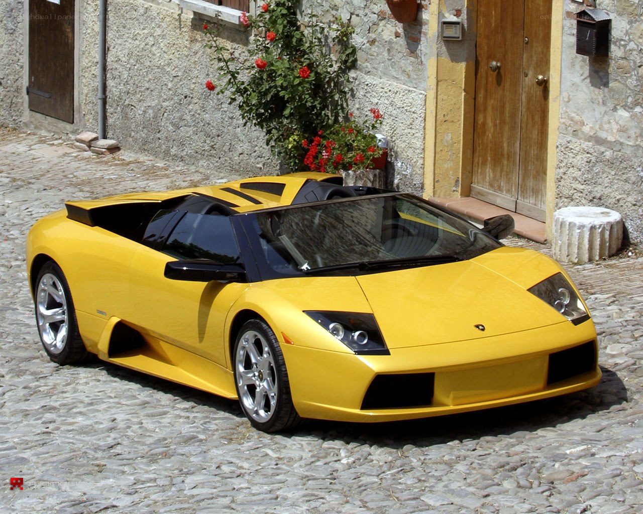 Yellow Lamborghini on cobblestone street