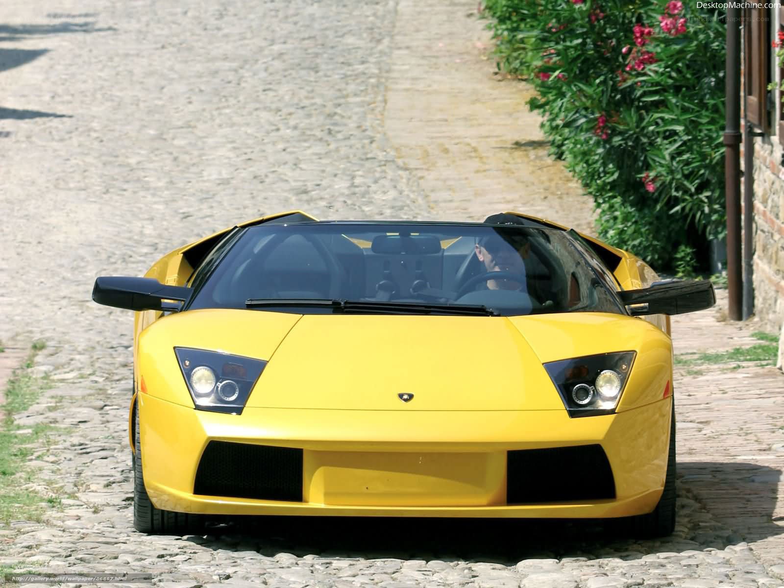 Yellow Lamborghini on cobblestone street