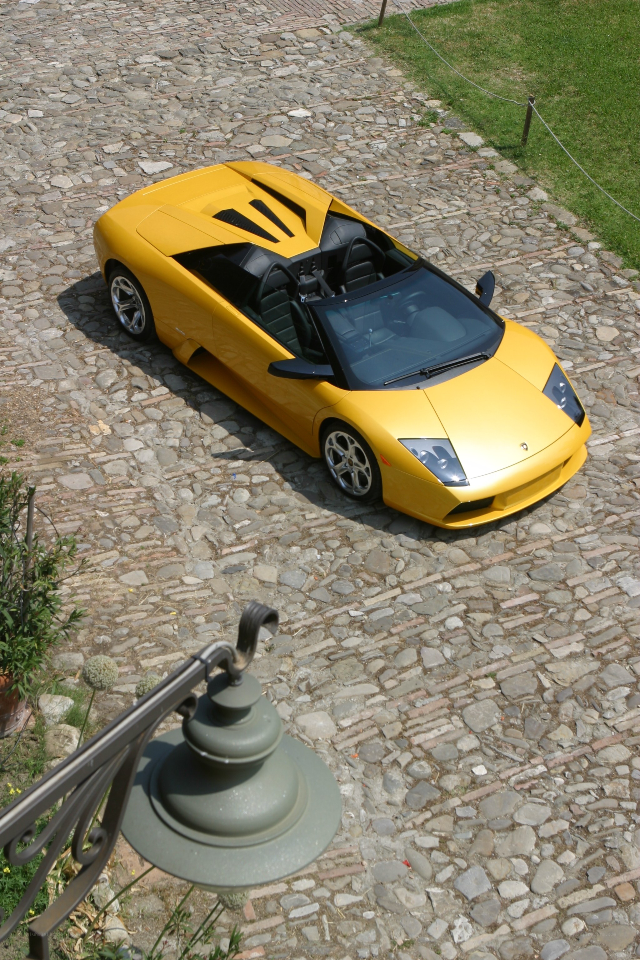 Yellow Lamborghini on cobblestones