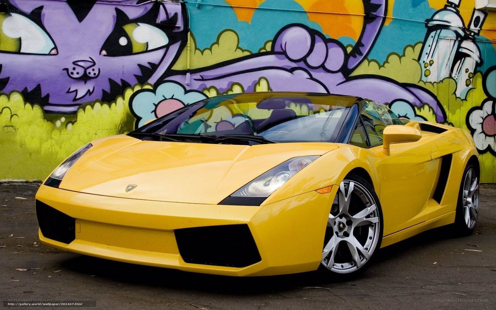 Yellow Lamborghini on graffiti wall
