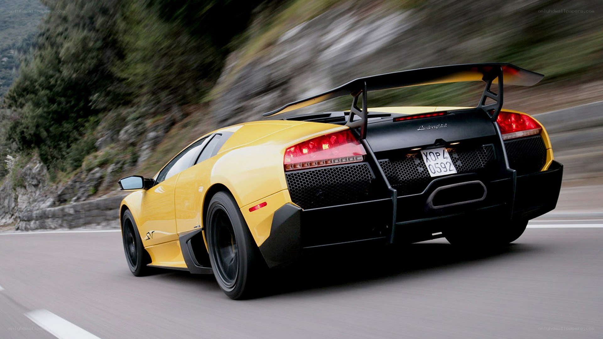 yellow lamborghini on mountain road