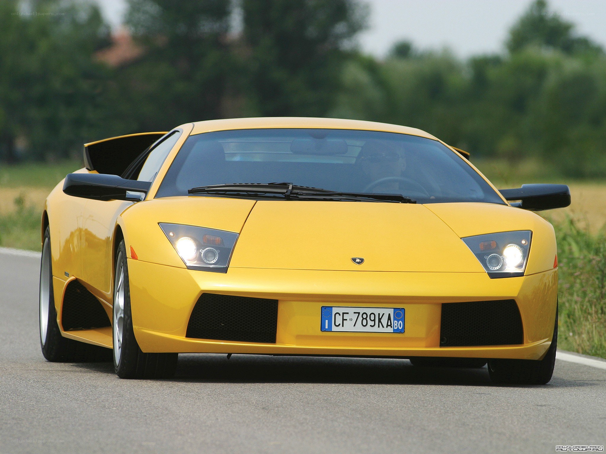 yellow lamborghini on road