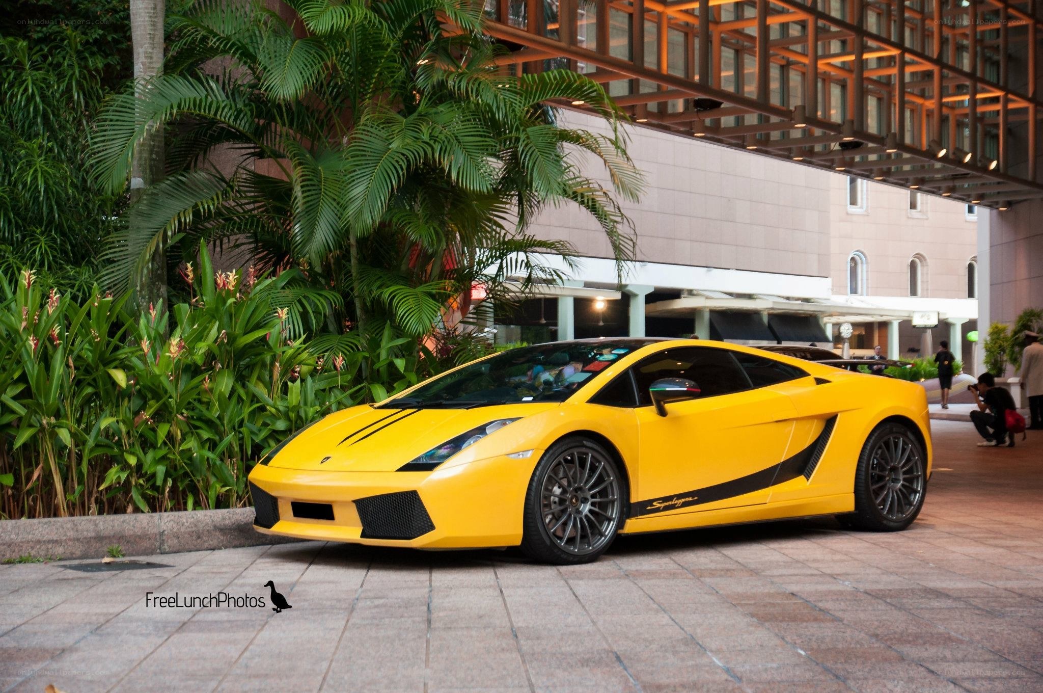 Yellow Lamborghini parked outside hotel